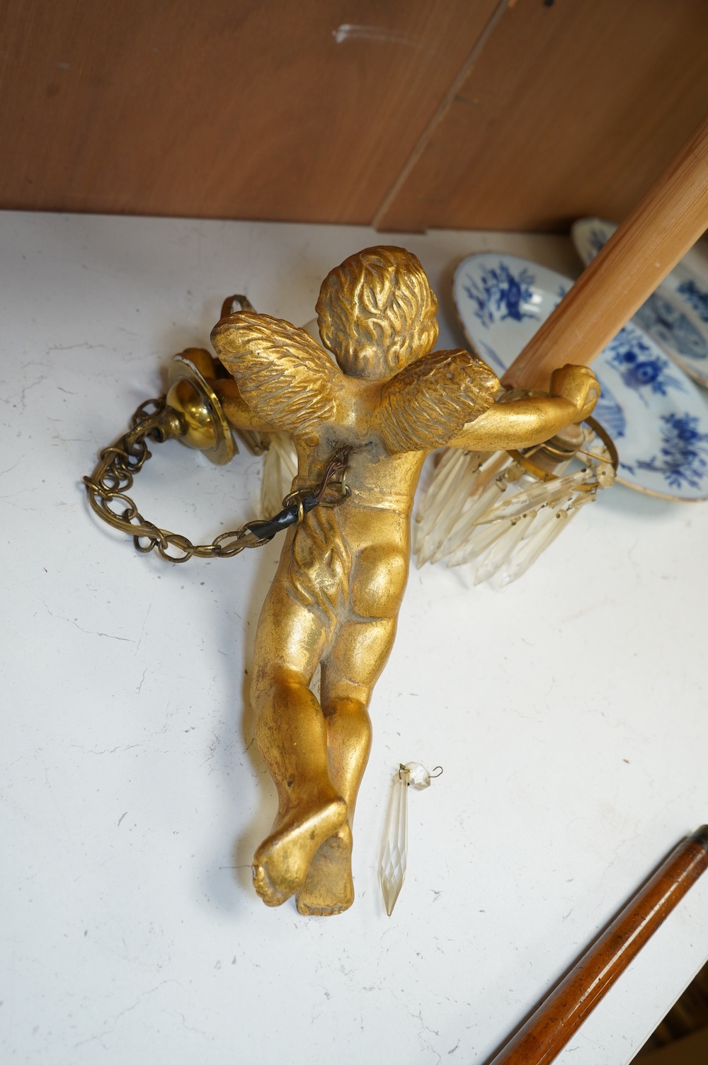 A gilt plaster hanging ‘cherub’ light fitting, 33cm long. Condition - fair